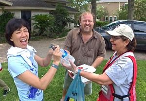 Xiaodi Lin and Robert Raphael were surprised to have lunch and other disaster supplies and information delivered by the Red Cross.  They were clearing out soggy drywall from their flood-damaged home when the Red Cross workers stopped by to check on them. Shoba Brown, a Red Cross Volunteer from St. Joseph, Missouri, delivered lunch.  (Photo Credit: Mimi Teller/American Red Cross) 