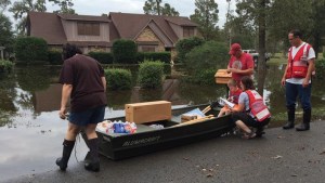 Colorado Mile High Chapter volunteers David Fugazzi and Linda Bisset find purpose in deploying to disaster sites like this one to help people in need. Here they're helping the Hardt family load supplies in their boat.
